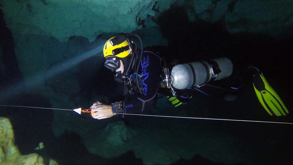 Diver placing a connection during cave diver training