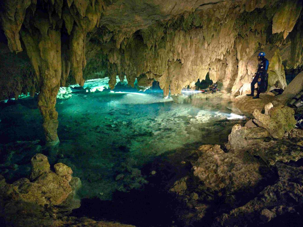 Cave divers admiring a newly discovered cenote in the Riviera Maya.