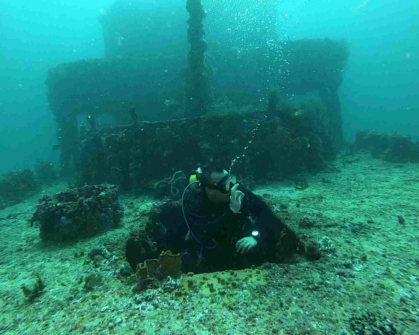 Diver emerging from C-56 wreck in Puerto Morelos