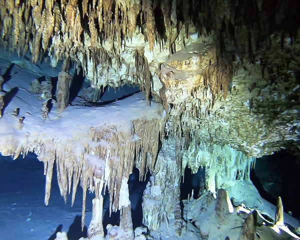 View of the fragile stalactites, stalagmites, and spectacular columns in Cenote Taak Bi Ha