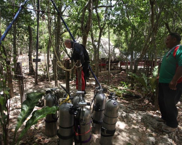 Divers are getting ready to lowering tanks in Cenote Taak Bi Ha