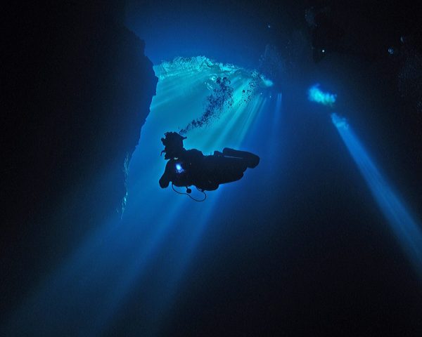 A diver decending The Pit, Tulum, Riviera Maya, Mexico